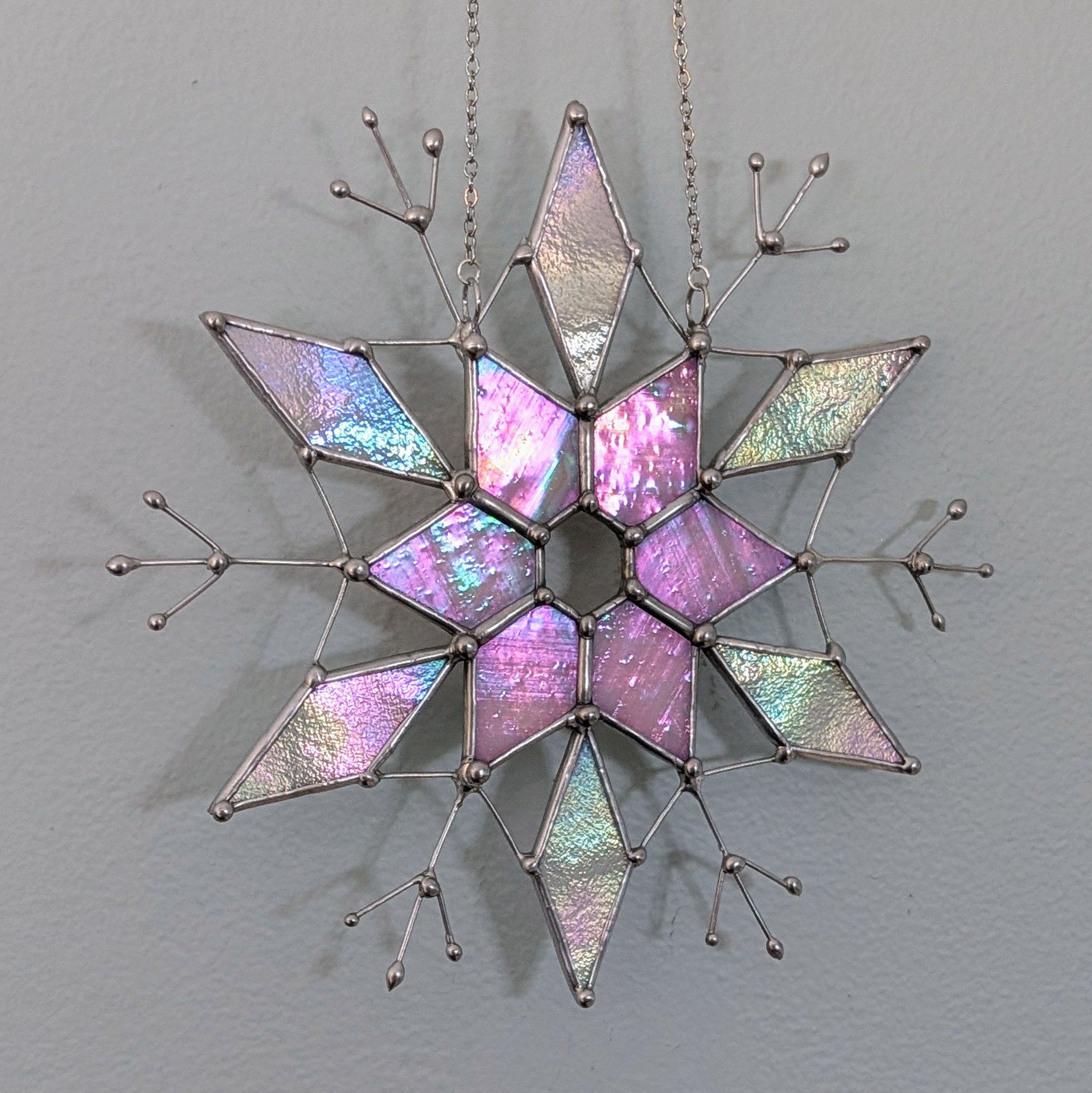 An iridescent stained glass snowflake